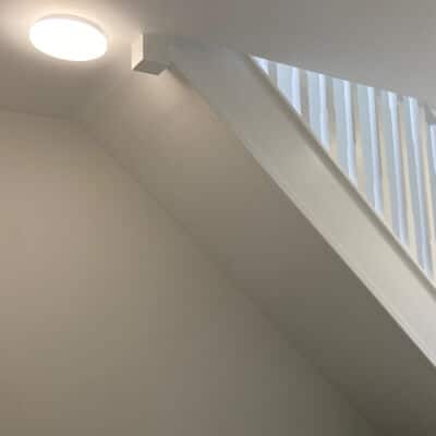 White-painted staircase to attic bedroom